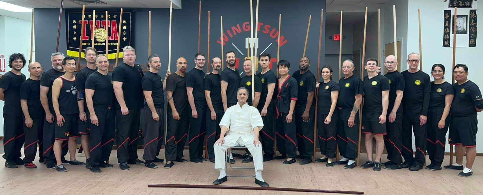 Instructors standing around Grandmaster Leung Ting at a Wing Tsun seminar